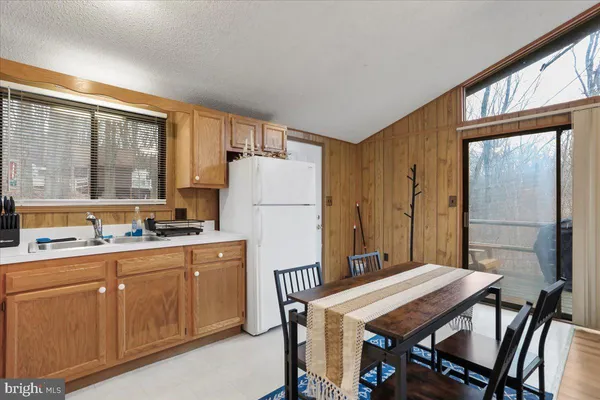 a kitchen that has a table and chairs in it