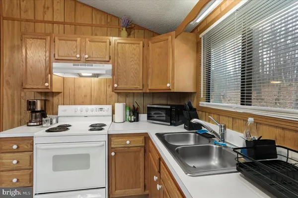 a kitchen with a sink cabinets and appliances