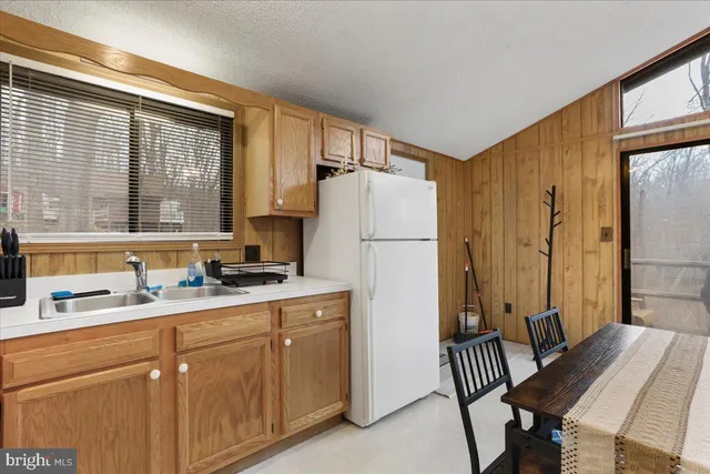 a kitchen with a refrigerator and a table