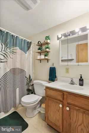 a white toilet sitting next to a bathroom sink
