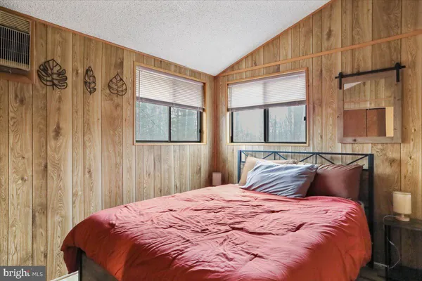 a bedroom with a bed and a curtain