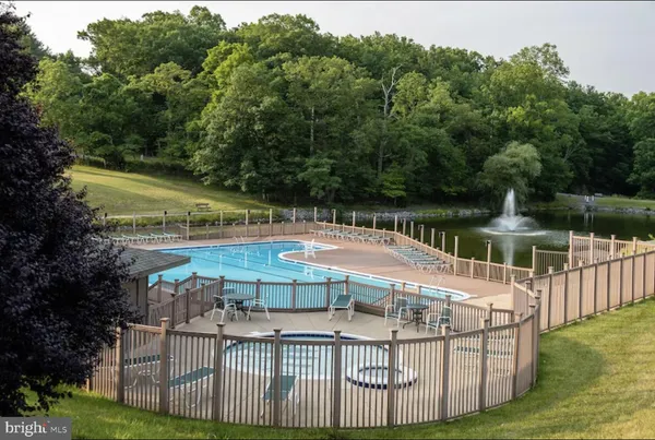 a view of a swimming pool with an outdoor seating and yard