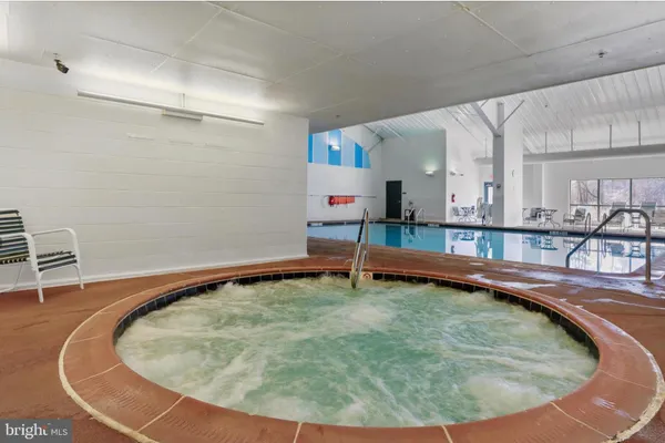 a view of a kitchen with kitchen island a large window cabinets and stainless steel appliances