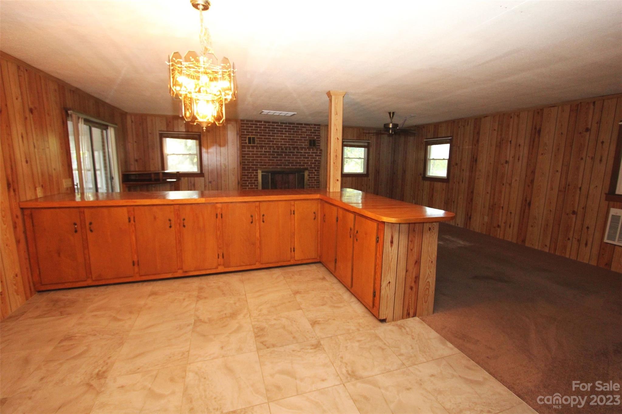 144 Allen Pond Road Wadesboro, NC 28170 - Photo 11 of 40 a view of a big room with windows and chandelier
