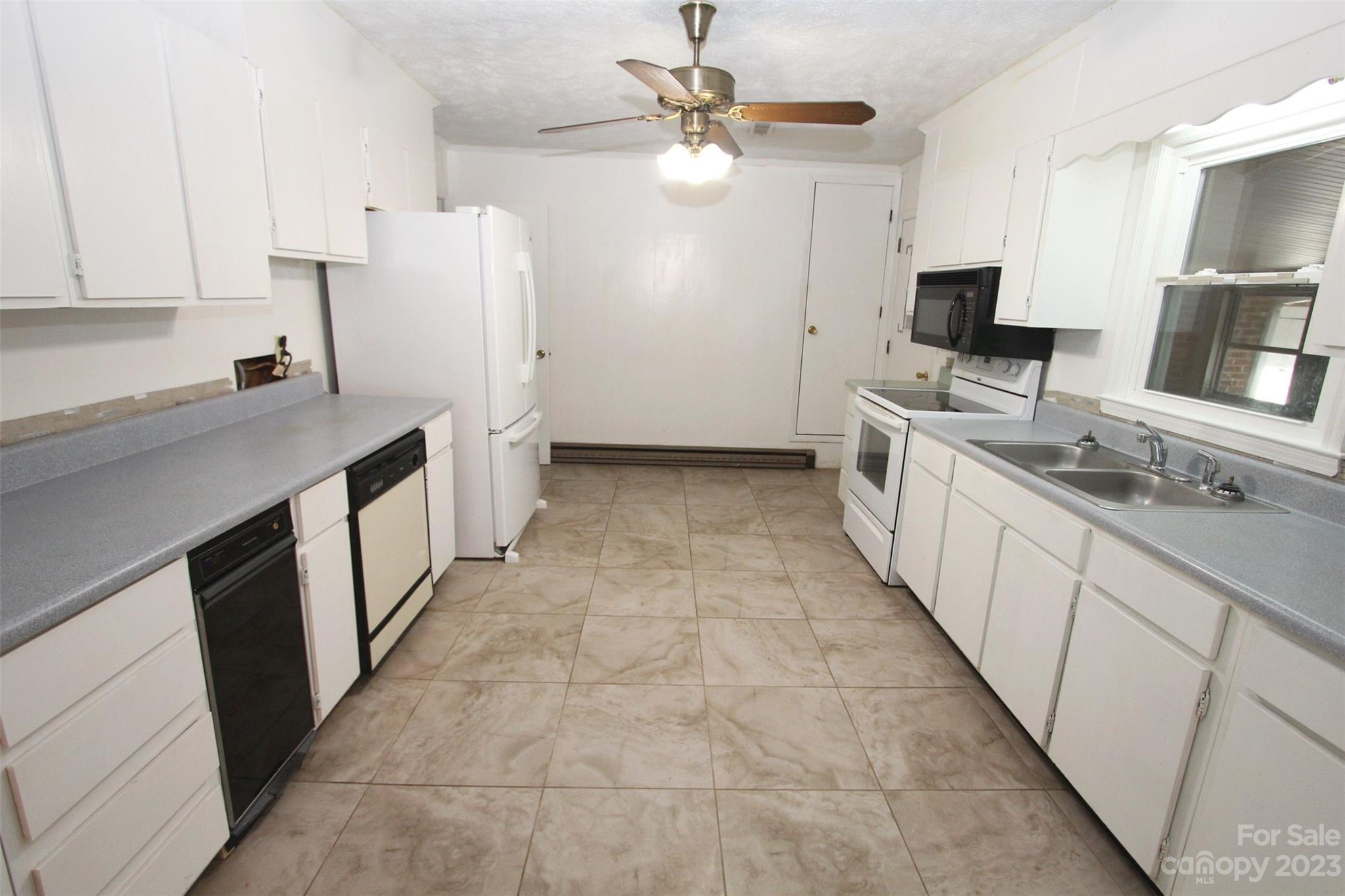 144 Allen Pond Road Wadesboro, NC 28170 - Photo 13 of 40 a kitchen with a sink stove and refrigerator