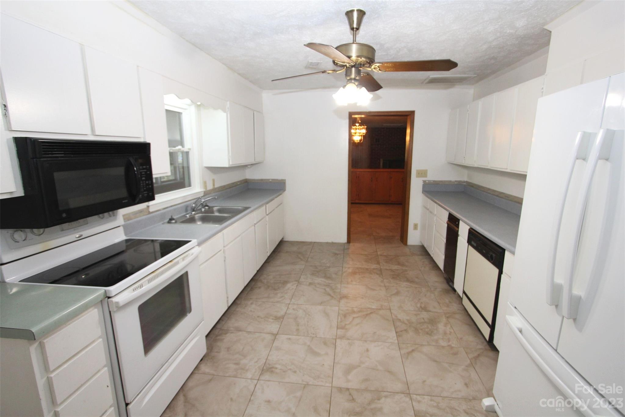 144 Allen Pond Road Wadesboro, NC 28170 - Photo 14 of 40 a kitchen with stainless steel appliances a stove a microwave and a refrigerator