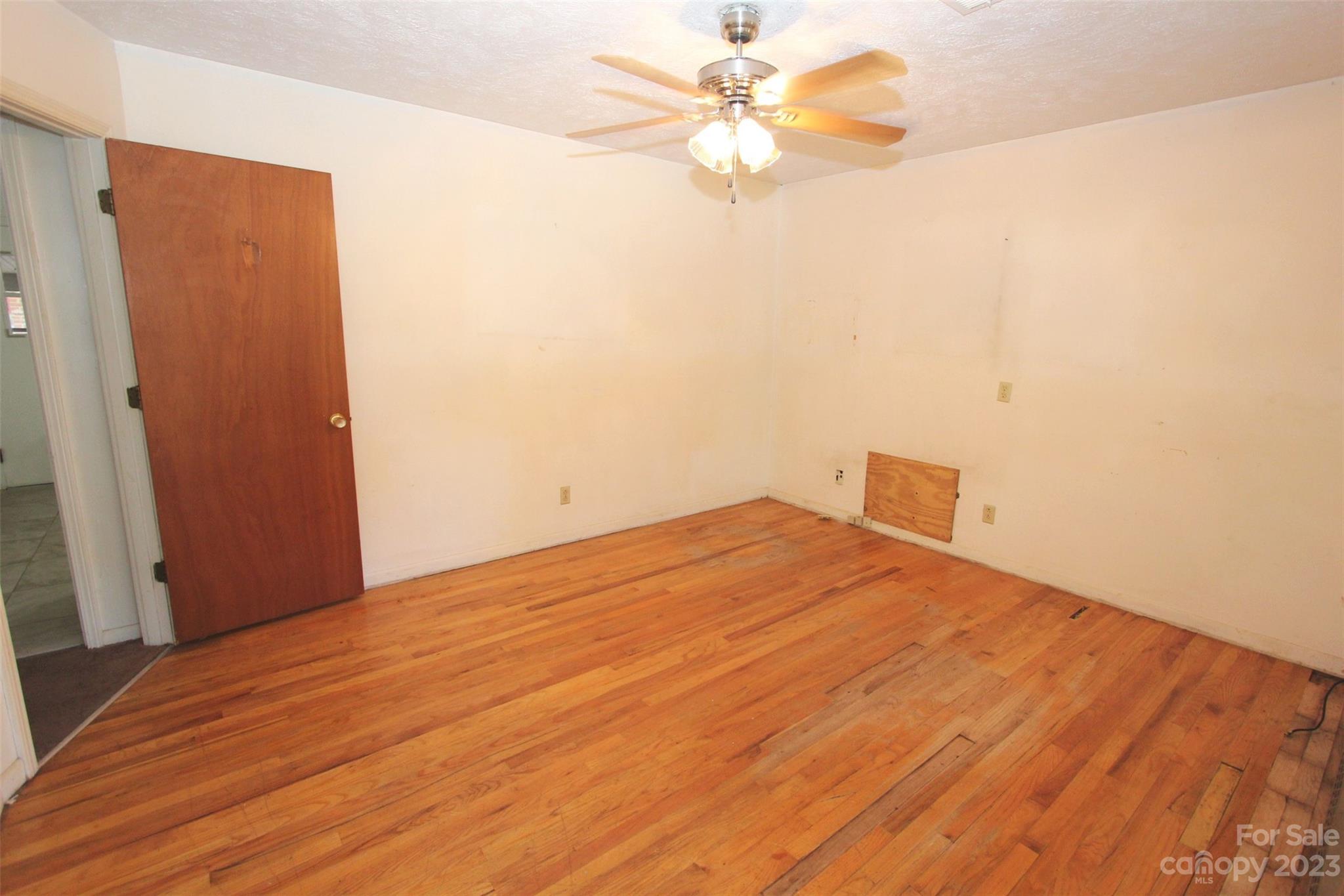 144 Allen Pond Road Wadesboro, NC 28170 - Photo 16 of 40 a bedroom with a bed and a chandelier