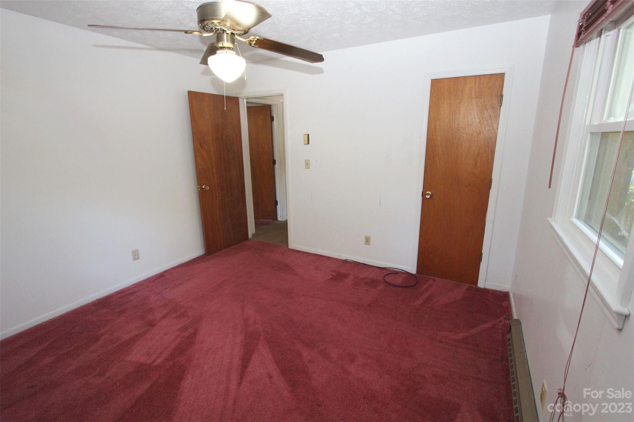144 Allen Pond Road Wadesboro, NC 28170 - Photo 23 of 40 a view of a hallway with a chandelier fan