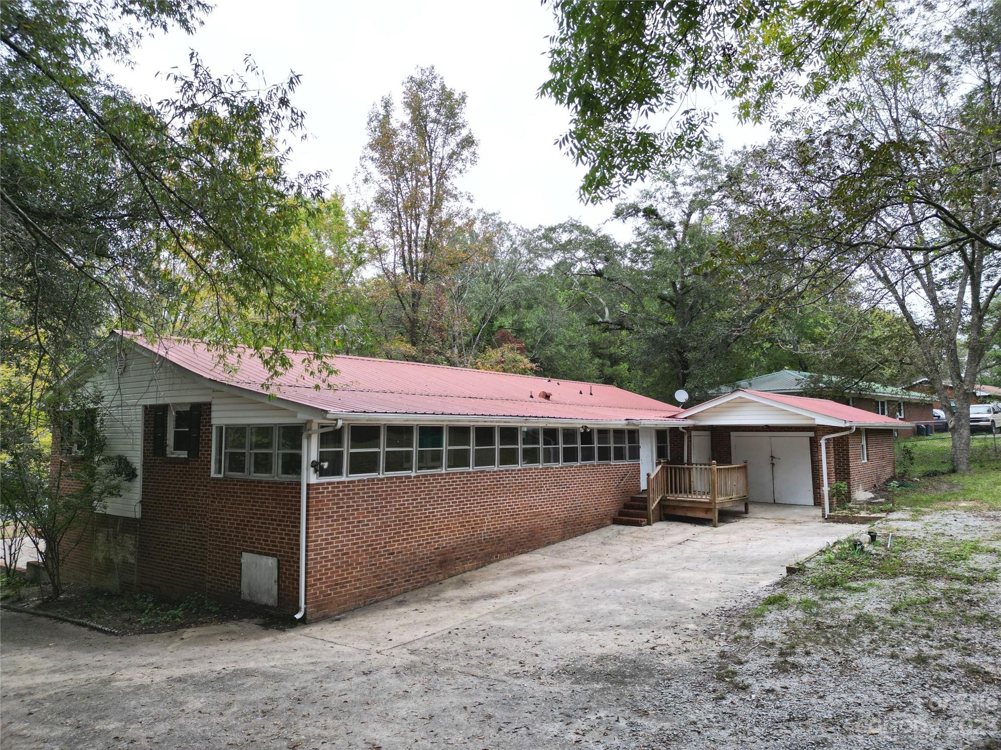 144 Allen Pond Road Wadesboro, NC 28170 - Photo 6 of 40 a view of a house with a yard and large trees