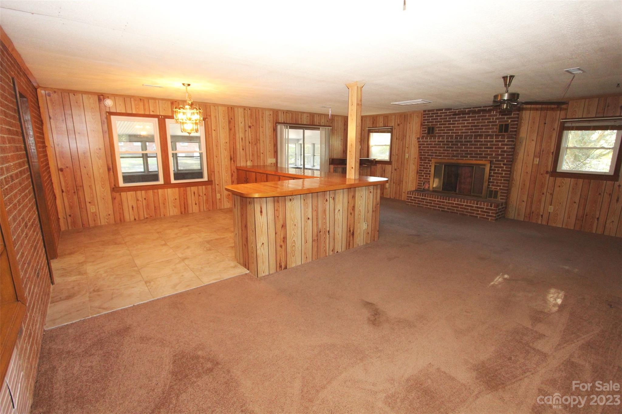144 Allen Pond Road Wadesboro, NC 28170 - Photo 10 of 40 an empty room with fireplace and windows