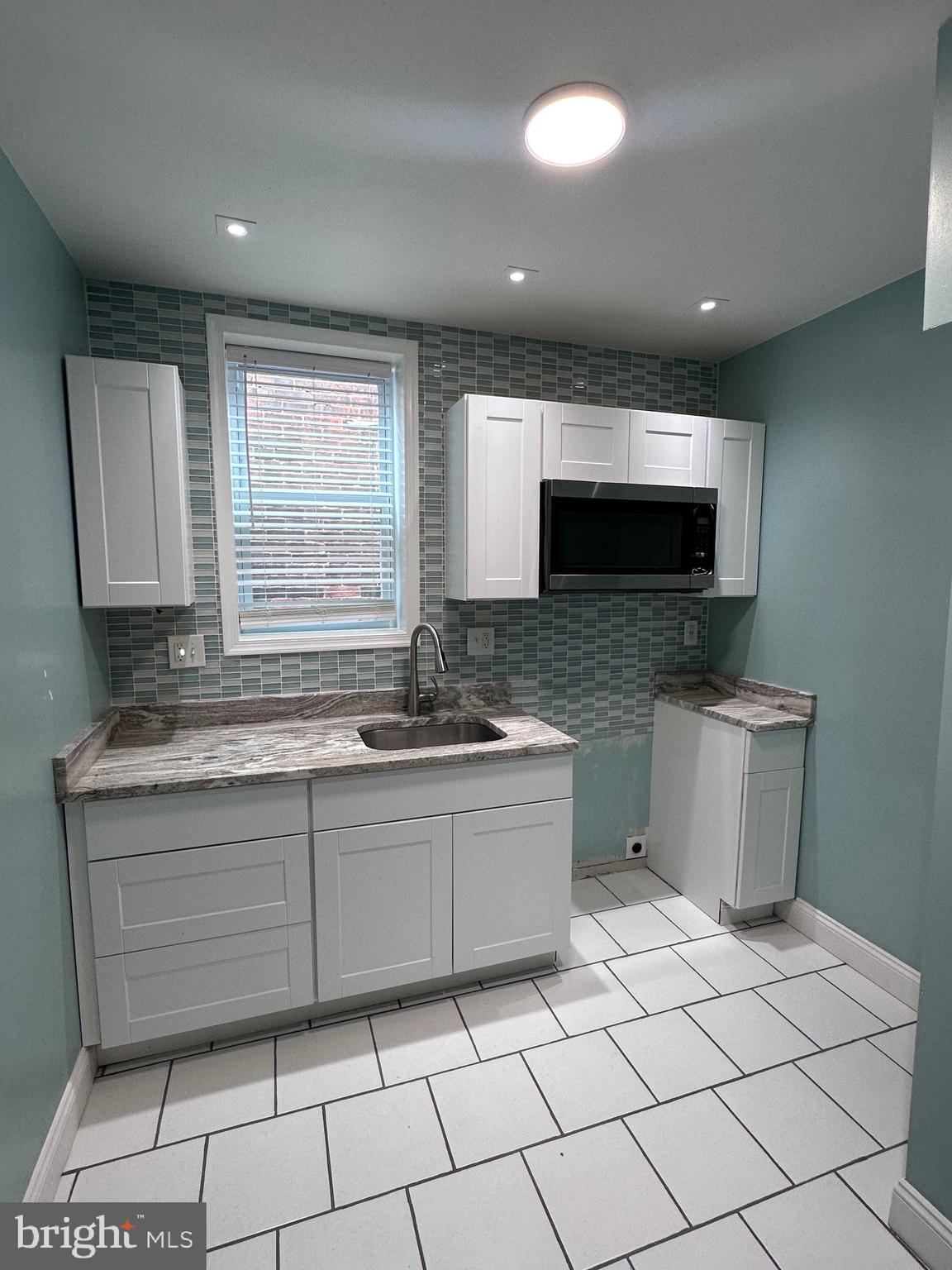 5254 Jefferson Street Philadelphia, PA 19131 - Photo 24 of 30 a bathroom with a sink a mirror and a bathtub