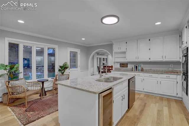a kitchen with sink stove and cabinets