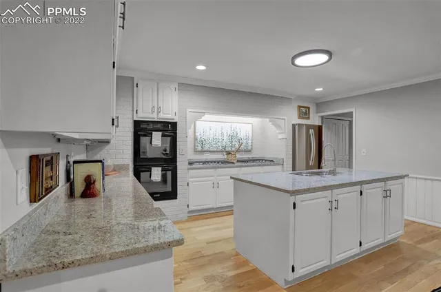 a kitchen with stainless steel appliances granite countertop a sink counter space and cabinets