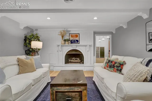 a living room with furniture fireplace and a fireplace