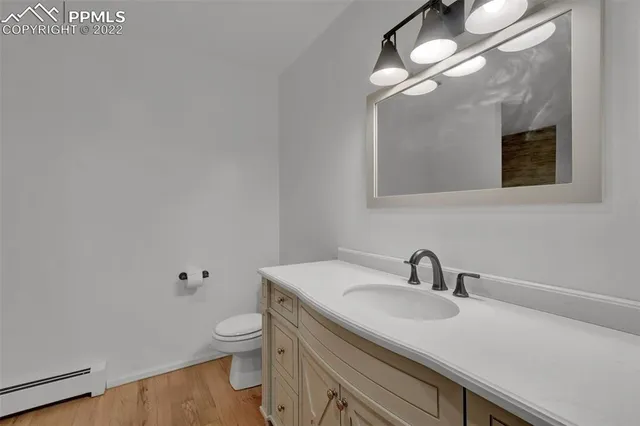 a bathroom with a toilet a sink and mirror