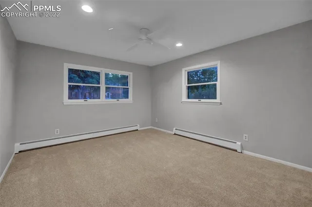 an empty room with a ceiling fan