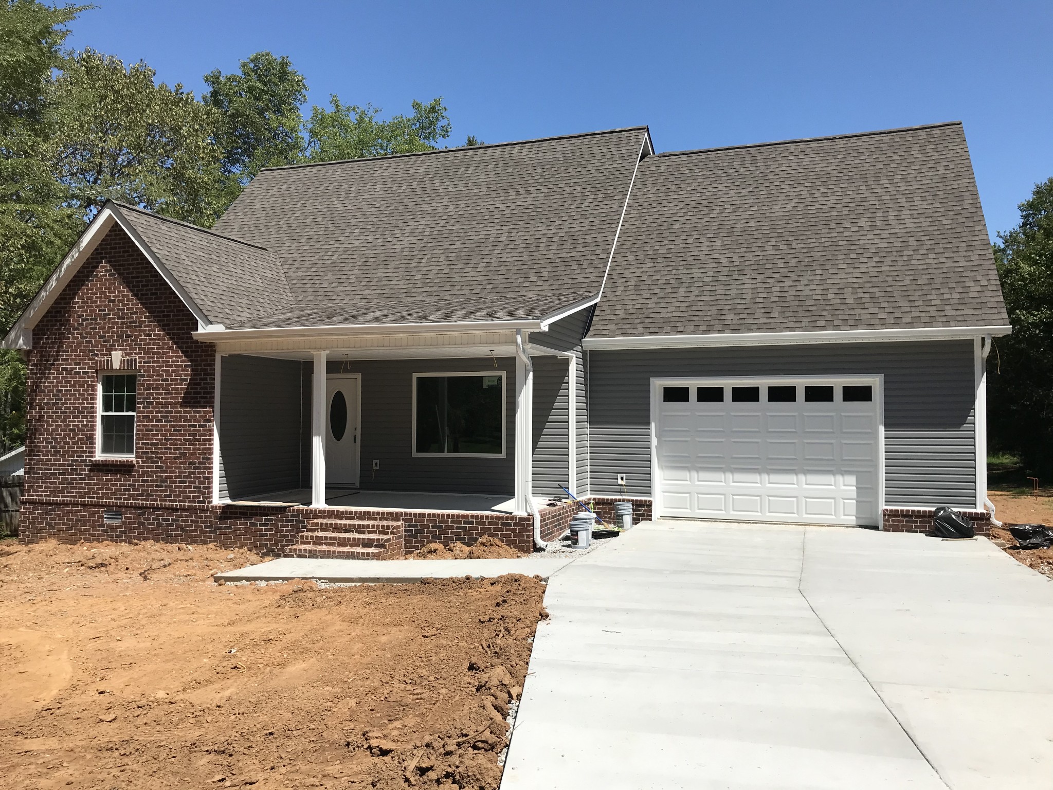 1141 Hamilton Chambers Road Lebanon, TN 37087 - Photo 1 of 15 a front view of a house with a yard and garage