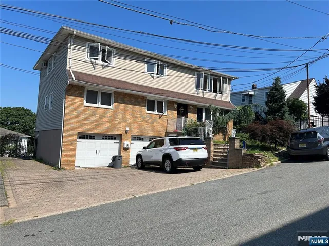 a view of a street that has couple of cars parked on the road