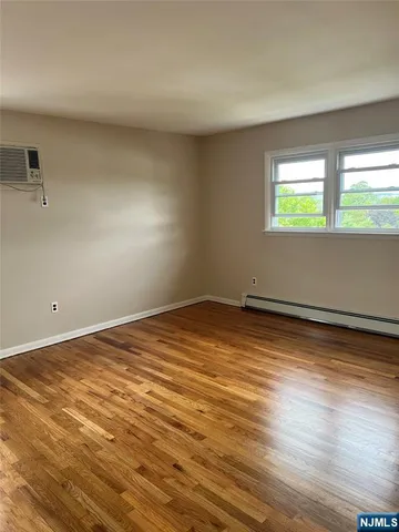 a view of a livingroom with a ceiling fan and wooden floor