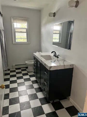 a kitchen with a sink a stove and a mirror