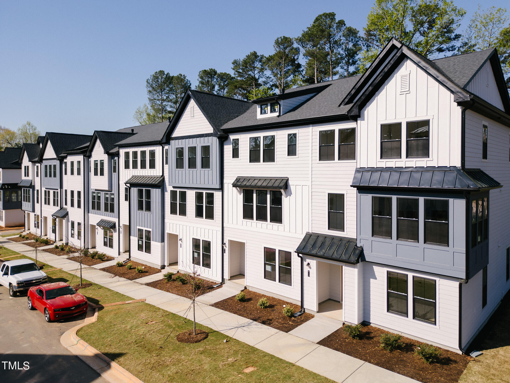 6421 Tanner Oak Lane Raleigh, NC 27613 - Photo 1 of 36 a view of a large white building with large windows