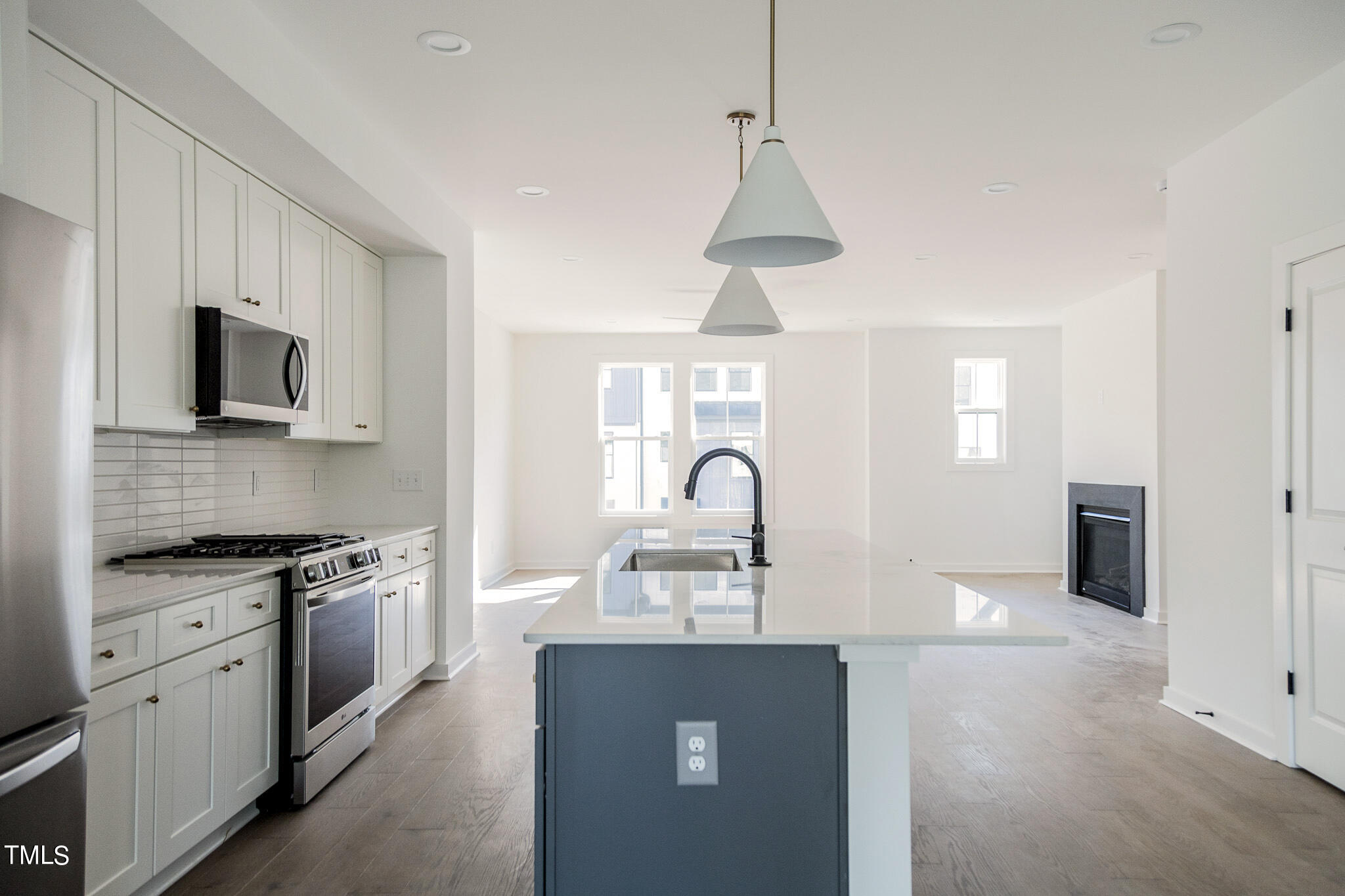 6421 Tanner Oak Lane Raleigh, NC 27613 - Photo 4 of 36 a kitchen with stainless steel appliances granite countertop a stove a sink a refrigerator and a granite counter tops