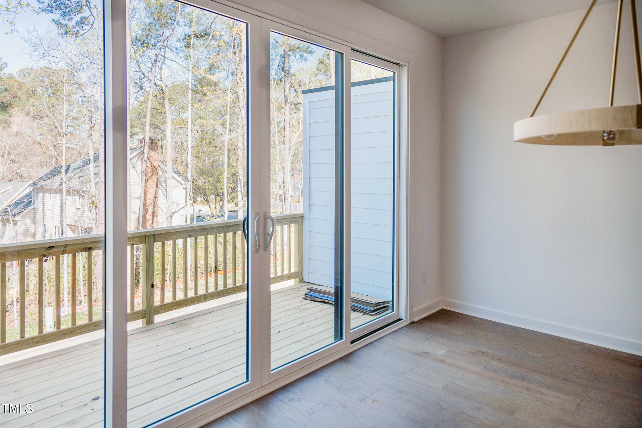 6421 Tanner Oak Lane Raleigh, NC 27613 - Photo 6 of 36 a view of a room with wooden floor and windows
