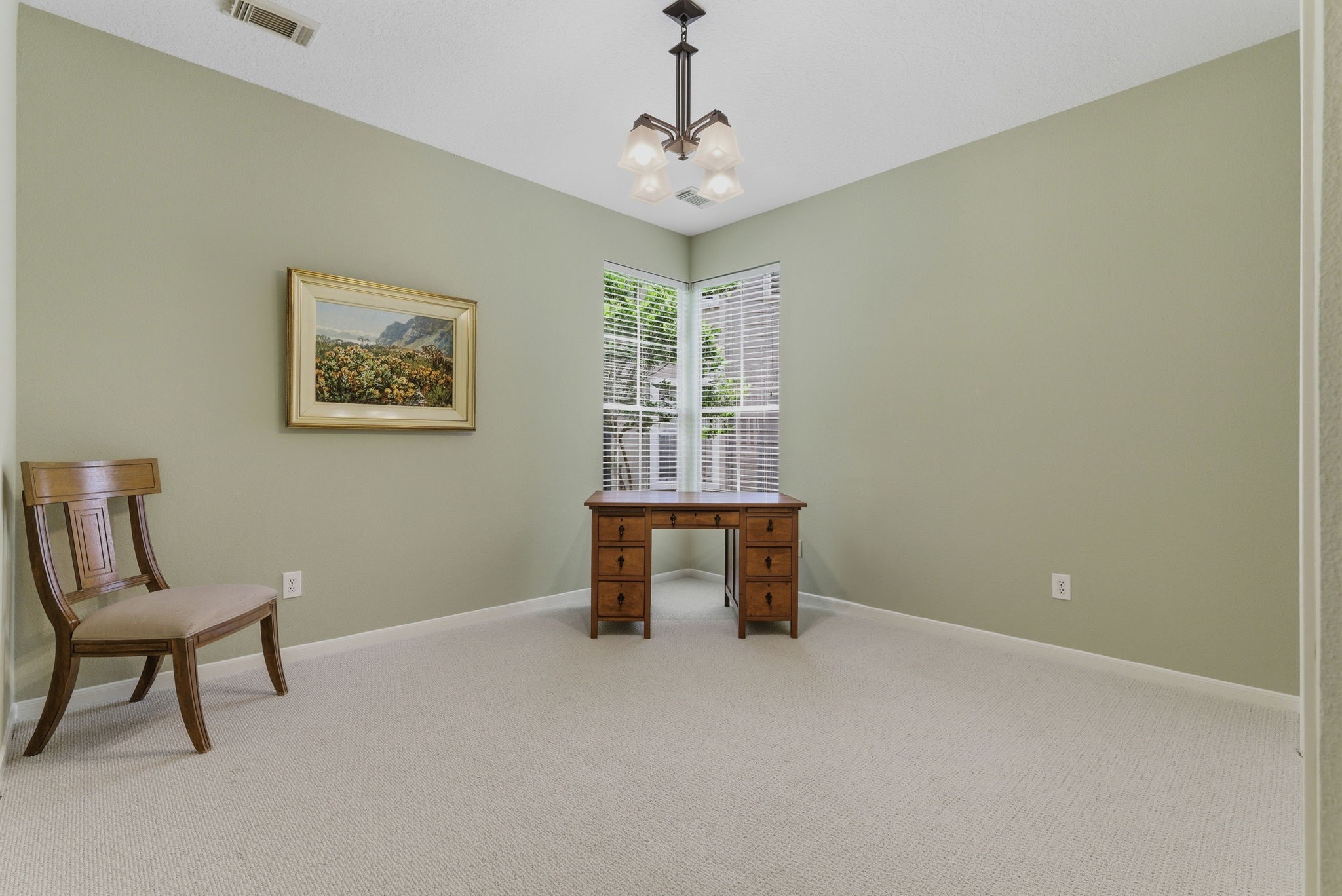 11 Dovewing Place Spring, TX 77382 - Photo 16 of 32 Beautiful front room could serve as an office space, bedroom, or exercise area. Features soft green walls, and light carpet.