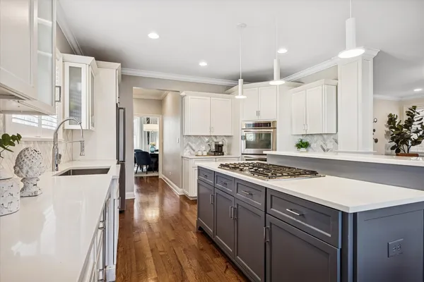 a kitchen with a stove a sink and a refrigerator