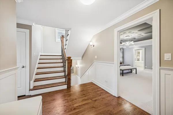 a view of entryway with wooden floor and stairs