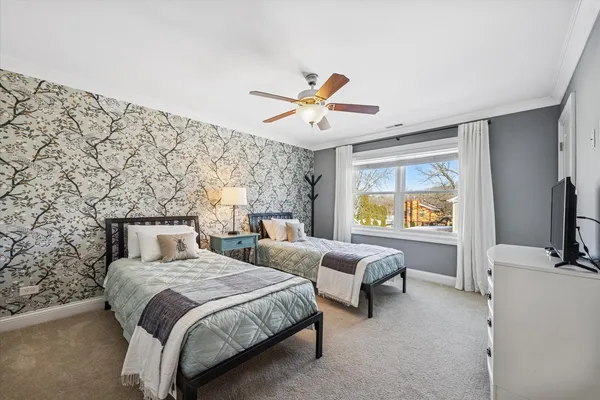 a bedroom with double bed and a large window