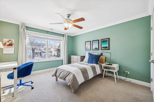 a bedroom with a bed chair and a window
