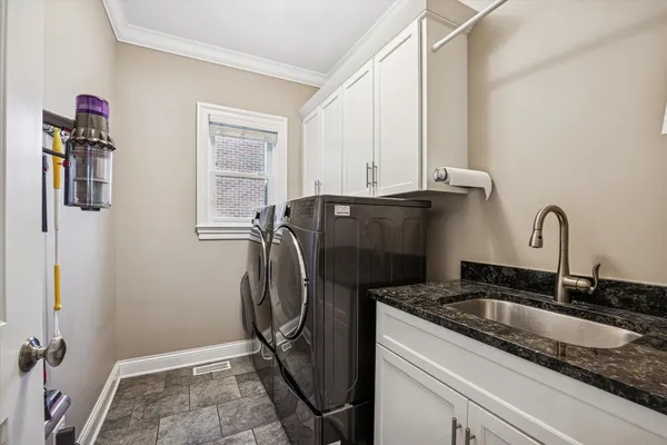 a bathroom with a sink and a washing machine