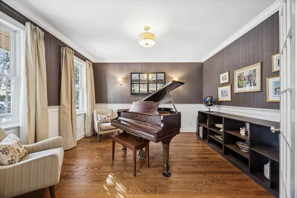 a living room with furniture and a piano