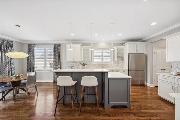 a kitchen with stainless steel appliances granite countertop a table and chairs