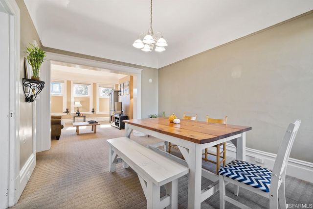a room with furniture a chandelier and a table