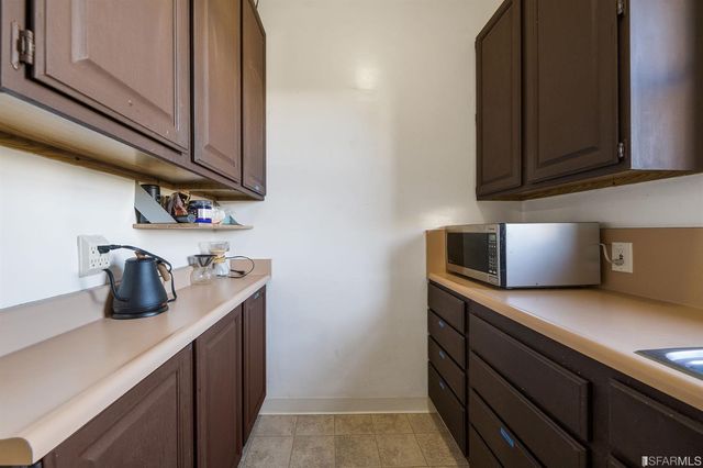 a kitchen with cabinets and a microwave oven