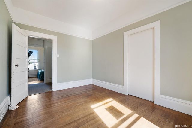 a view of a room with wooden floor
