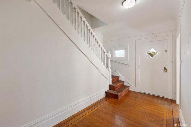 a room with stairs and a wooden floor