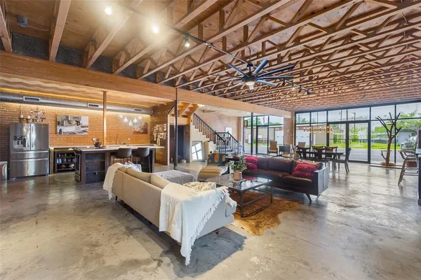 a living room with furniture and a chandelier