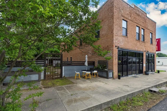 a backyard of a house with table and chairs