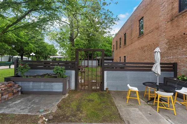 a view of a chairs and table in the backyard