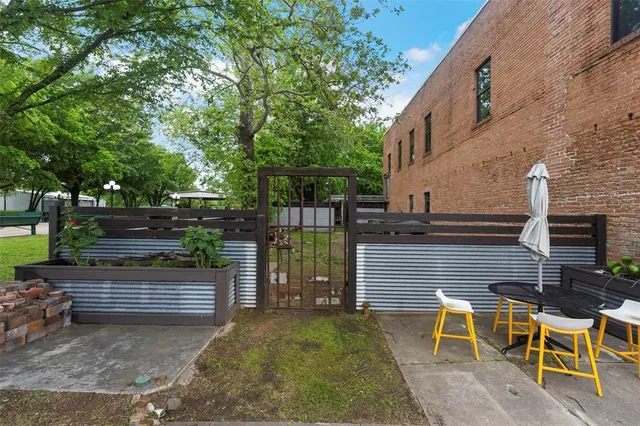 a view of a chairs and table in the backyard