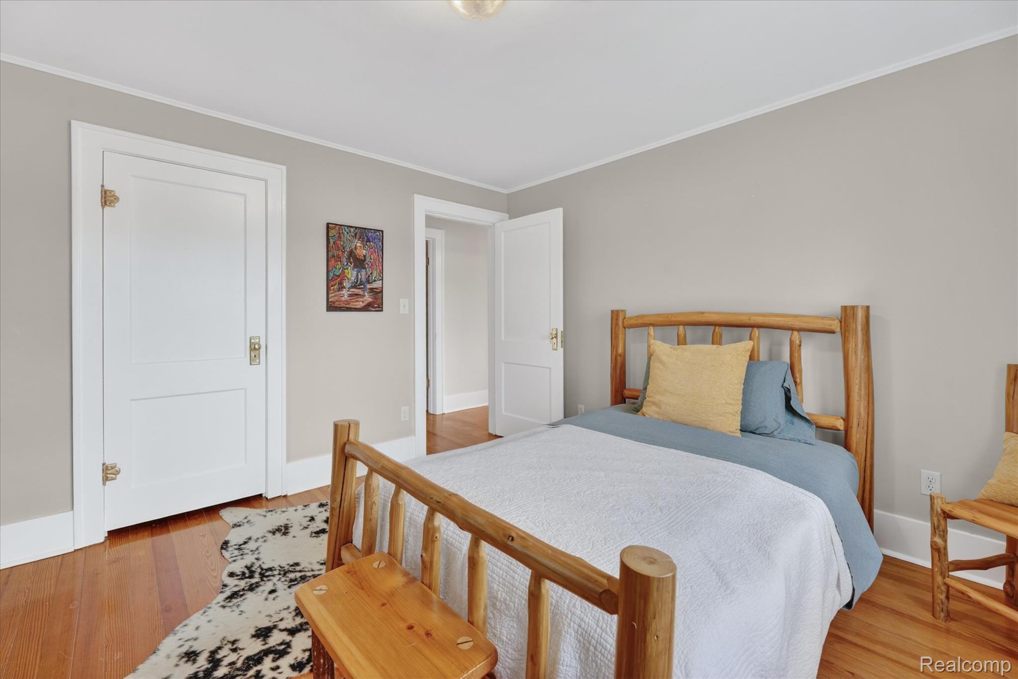 12409 Fenton Road Fenton, MI 48430 - Photo 26 of 61 Bedroom with crown molding and light wood finished floors