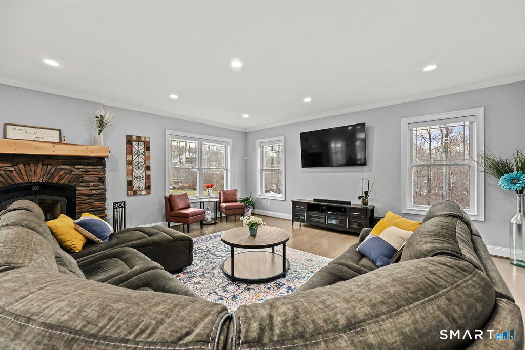 399 Hill Road Harwinton, CT 06791 - Photo 13 of 37 a living room with furniture and a flat screen tv