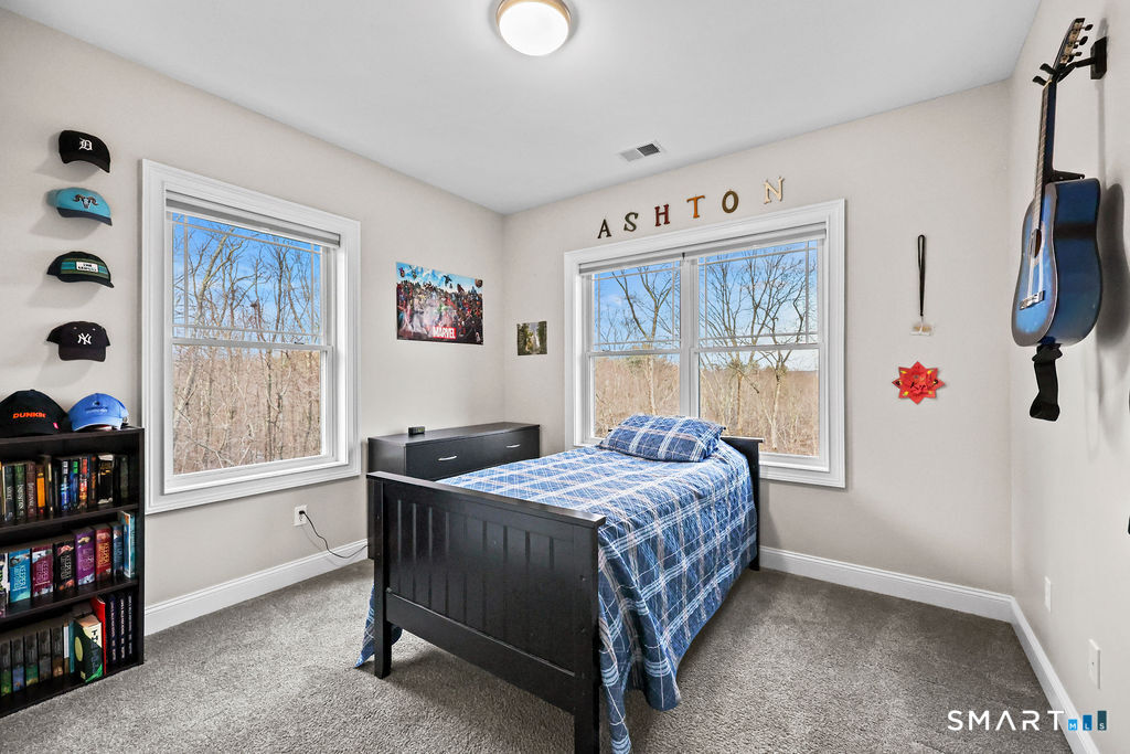 399 Hill Road Harwinton, CT 06791 - Photo 23 of 37 a bedroom that has a bed and a bookshelf in it