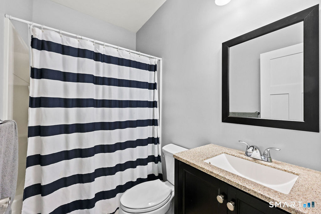 399 Hill Road Harwinton, CT 06791 - Photo 26 of 37 a bathroom with a sink a toilet a mirror and shower