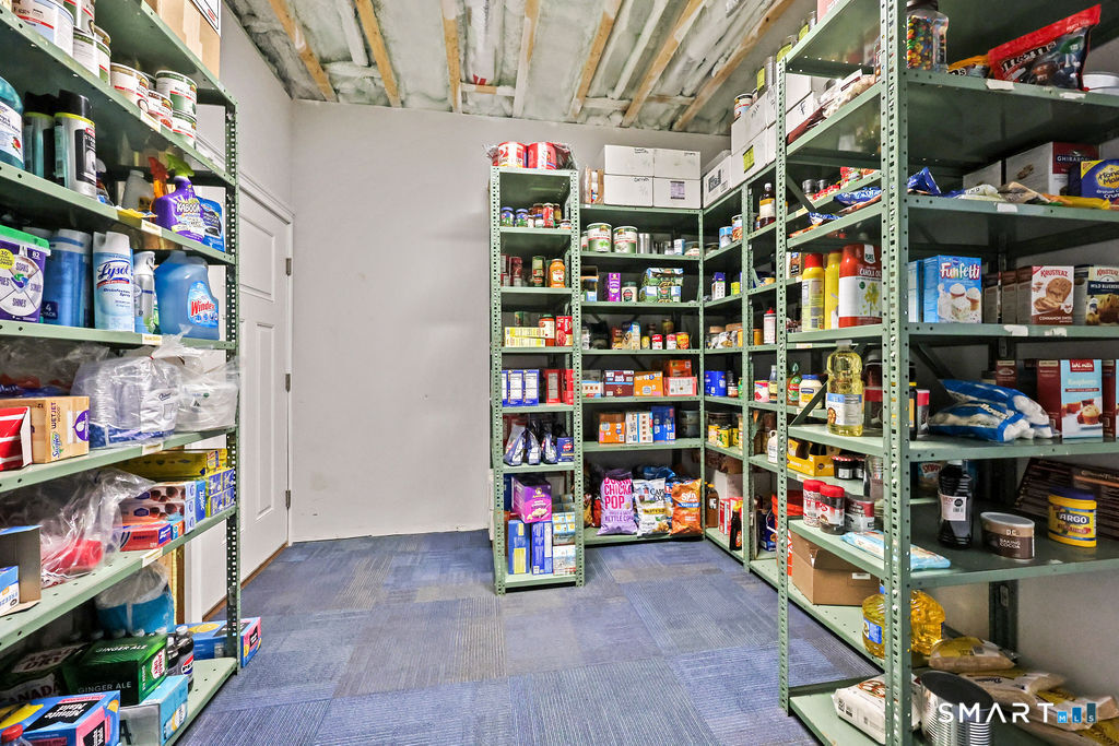 399 Hill Road Harwinton, CT 06791 - Photo 33 of 37 a room with lots of books and a refrigerator