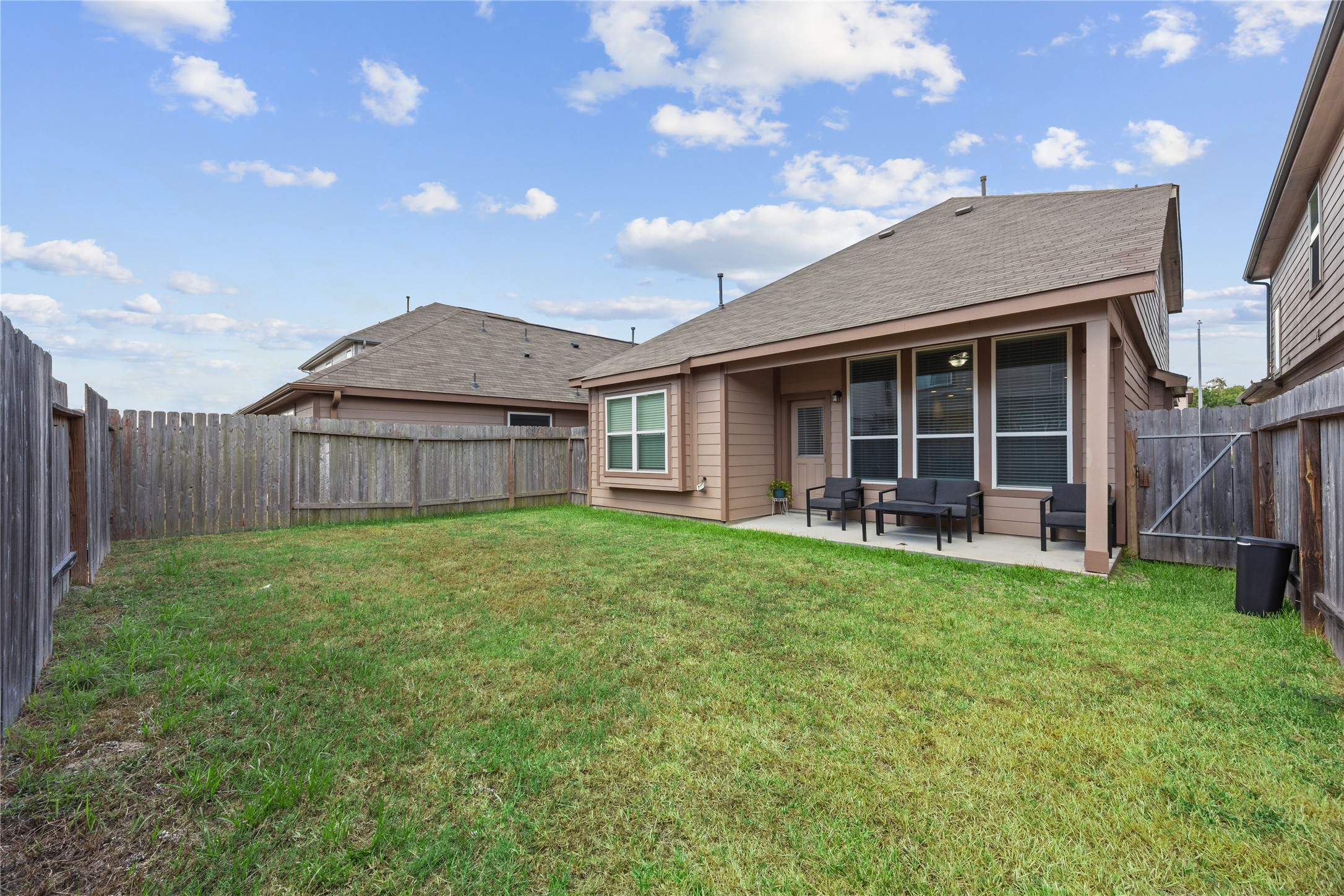 17514 Cuthbert Street Humble, TX 77346 - Photo 14 of 19 Spacious backyard with a cozy covered patio, perfect for outdoor relaxation and entertaining.