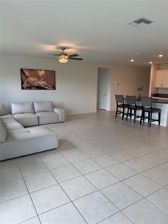 4461 Cozy Condor Court Bartow, FL 33830 - Photo 5 of 15 a living room with furniture a dining table and a projector